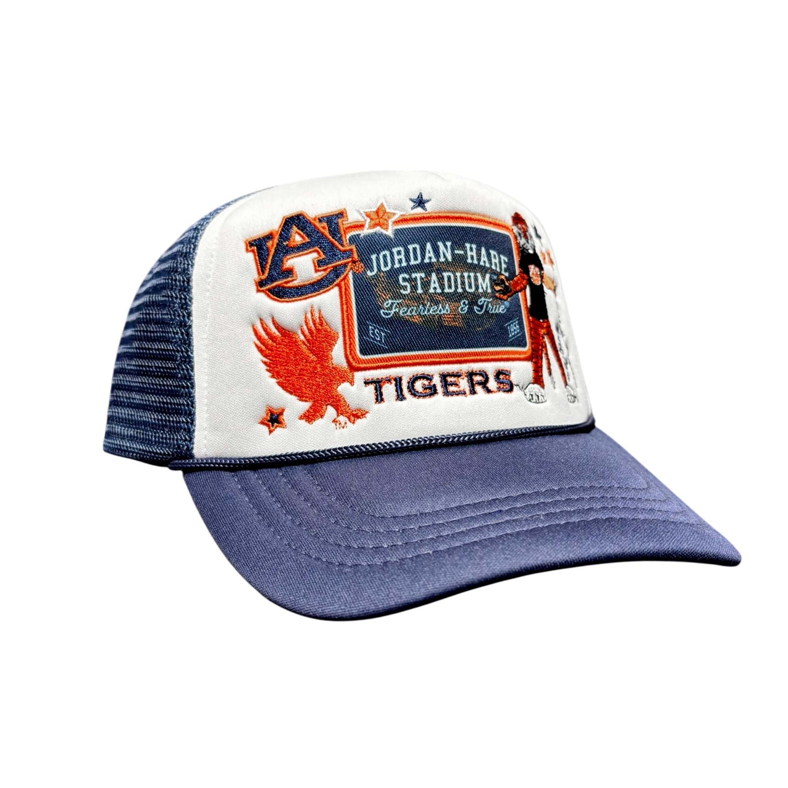 Close-up of white front panel Auburn trucker hat with embroidered Jordan-Hare Stadium patch design and navy bill