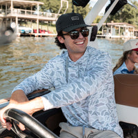 Guy sitting in the driver seat of a boat.