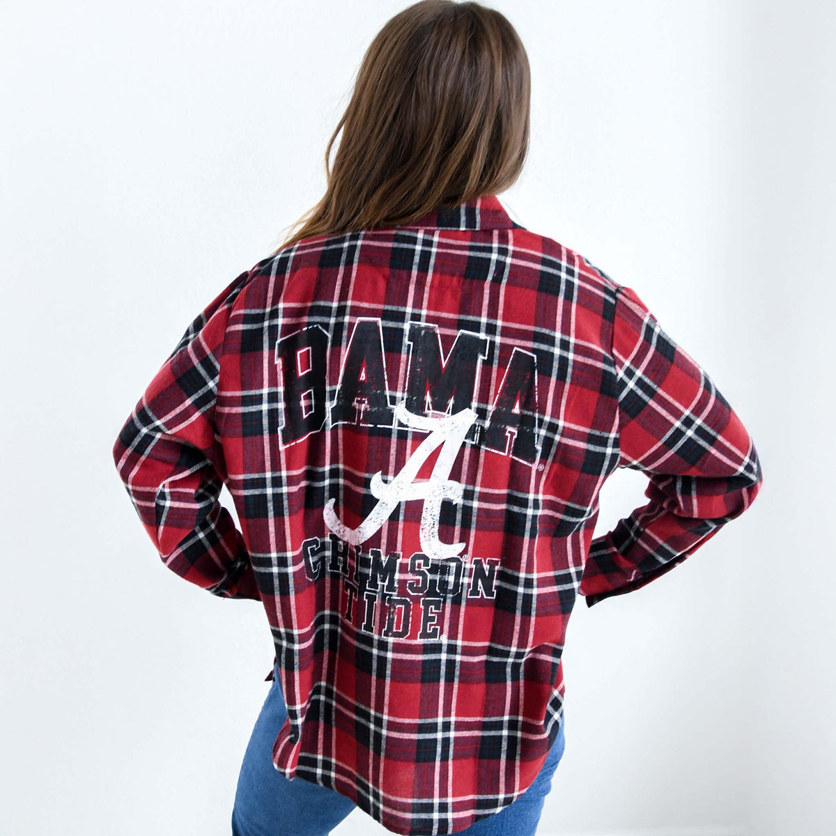 Back view of red and black plaid flannel shirt with large “BAMA” text, script “A” logo, and “Crimson Tide” graphic in white and black.
