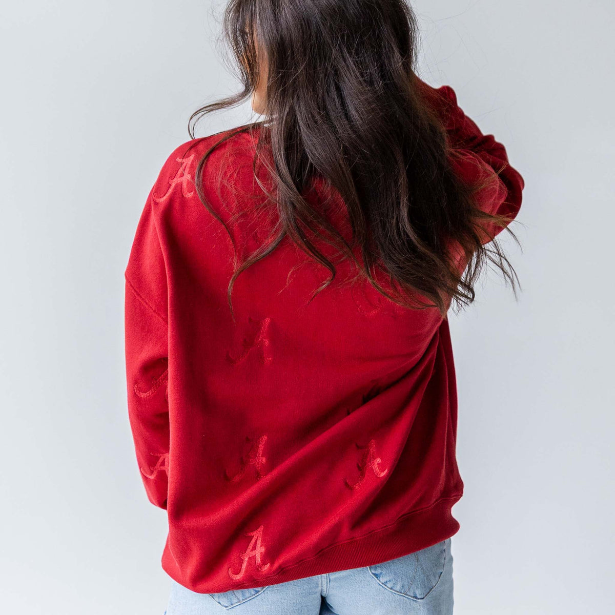 Back view of crimson crewneck sweatshirt with tonal Alabama “A” embroidery.