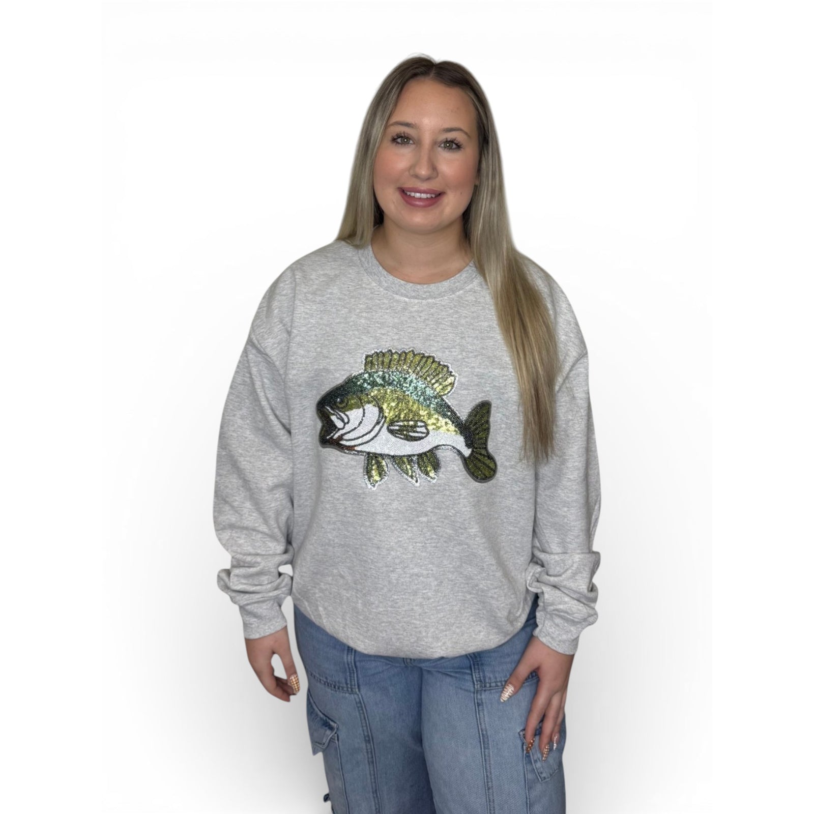 Woman wearing heather grey crewneck sweatshirt with large bass fish graphic on the front.