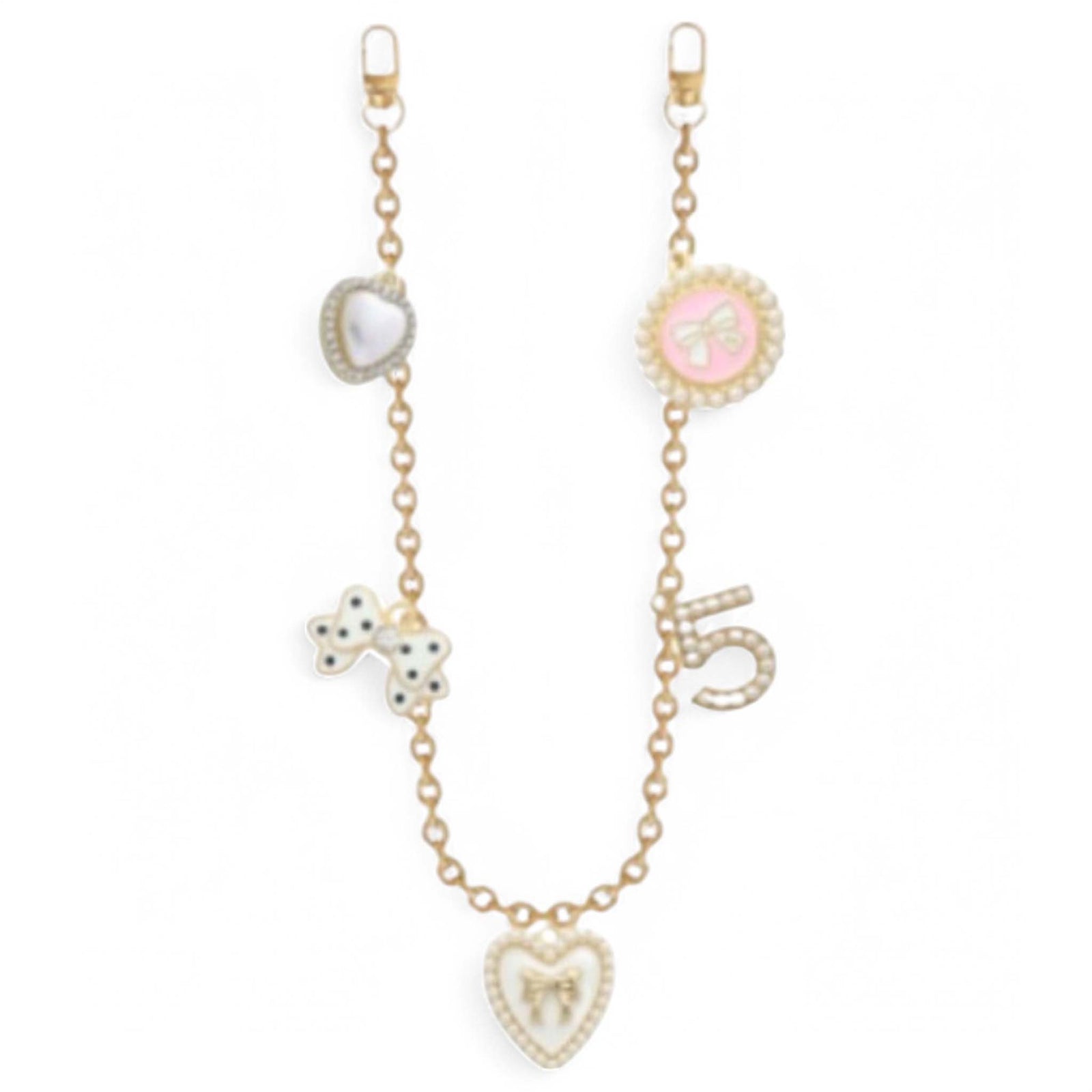 Add a touch of luxe to your look with this gold-plated bag chain, featuring a mix of playful and elegant charms.  Charms include - white puffed heart, white bow with black polka dots, white heart with gold bow, white beaded number 5, and a pink circle with a white bow in the middle. Designed to clip easily onto any bag, it brings instant shine and personality. The perfect way to elevate your everyday style. 