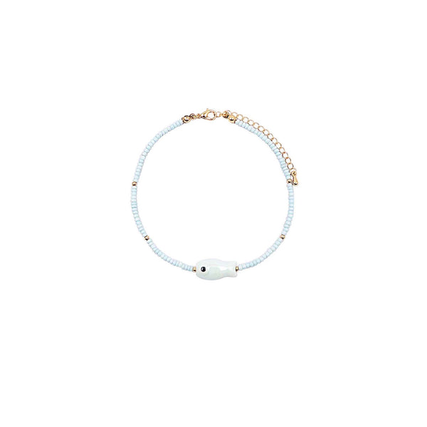 Anklet with light blue beads and a small fish charm on a white background