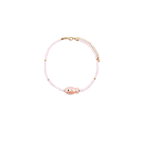 Anklet with pink beads, pink fish bead, and gold clasp on a white background