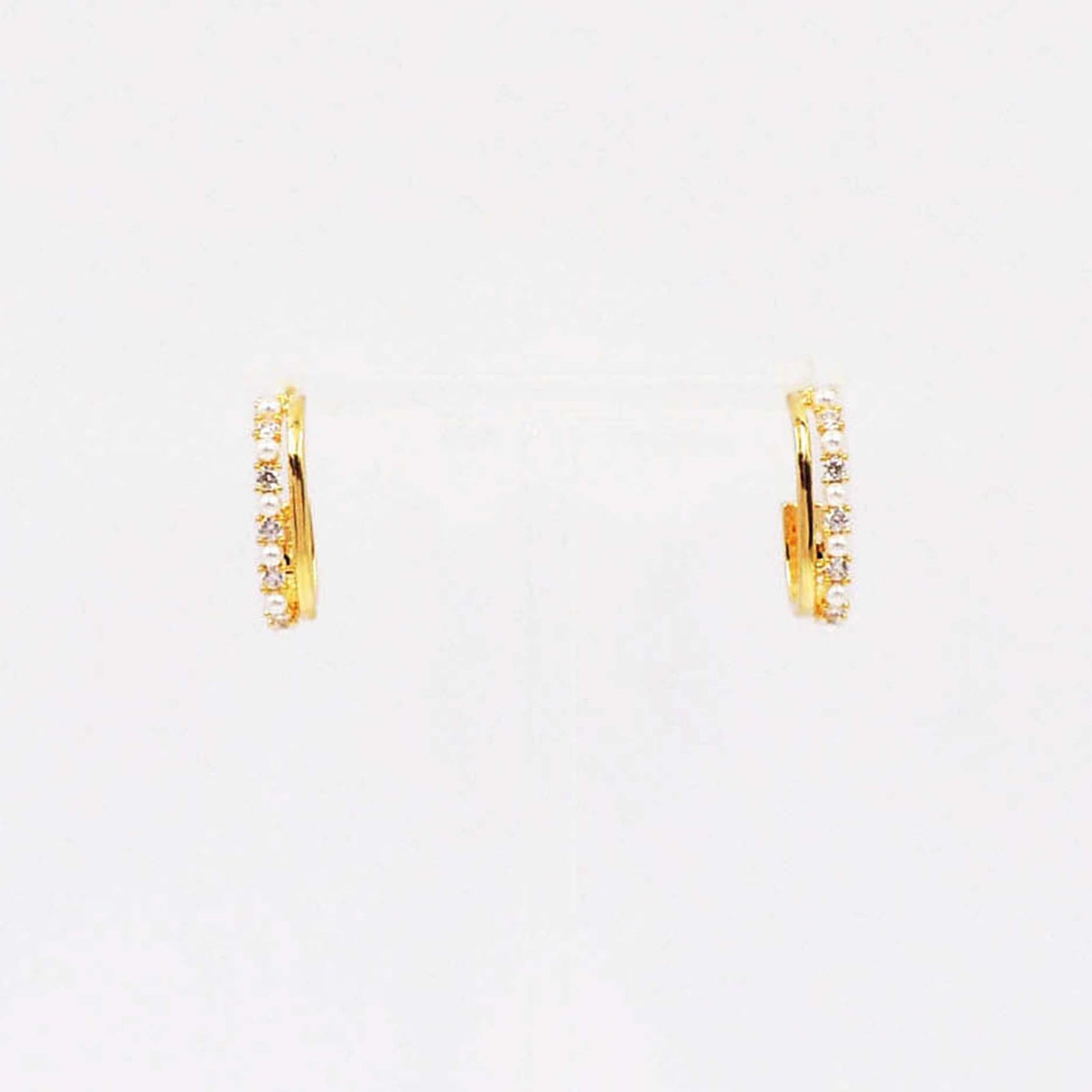 Gold huggie hoop earrings with full pave crystal and pearl detailing.