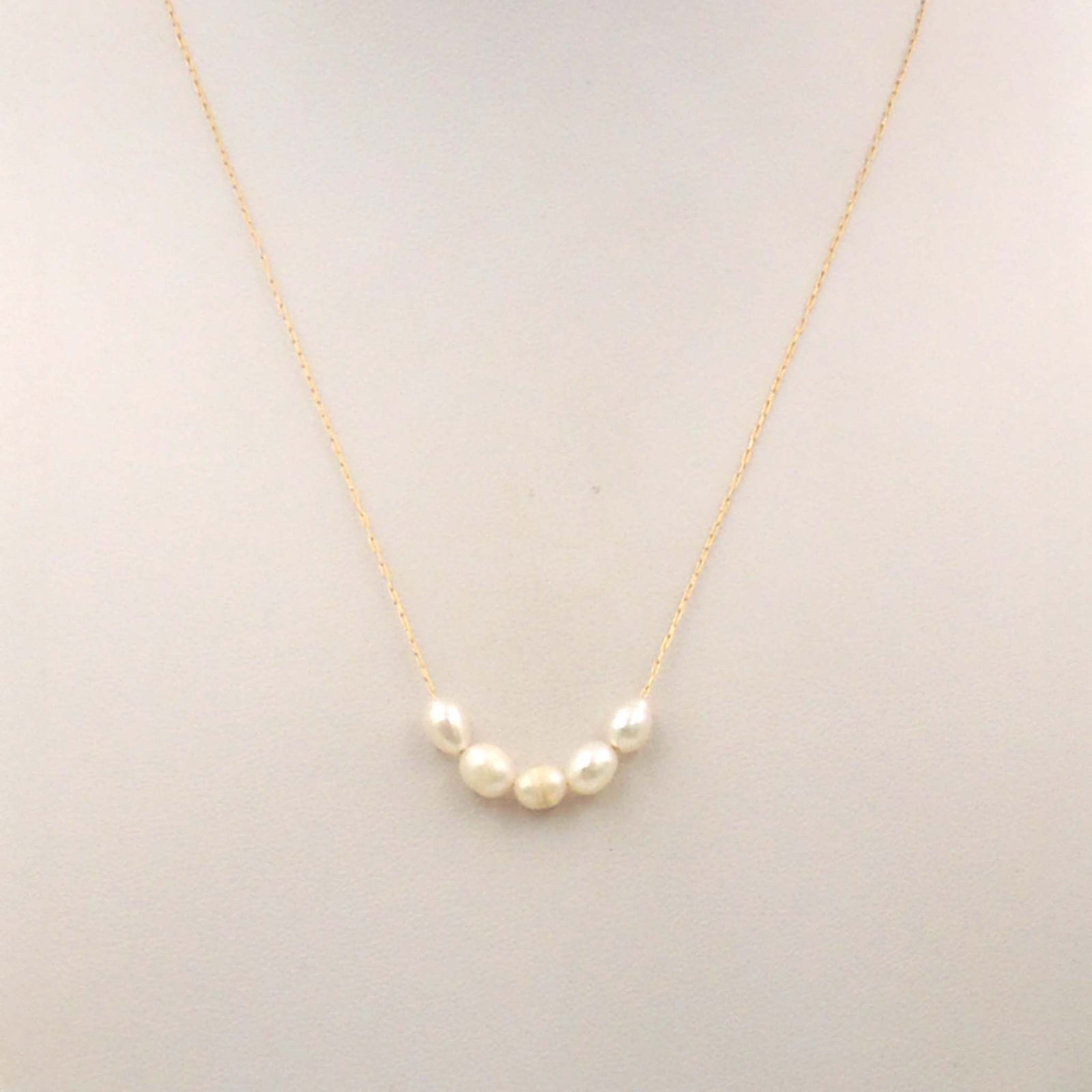 Gold chain necklace with 5 small white pearls