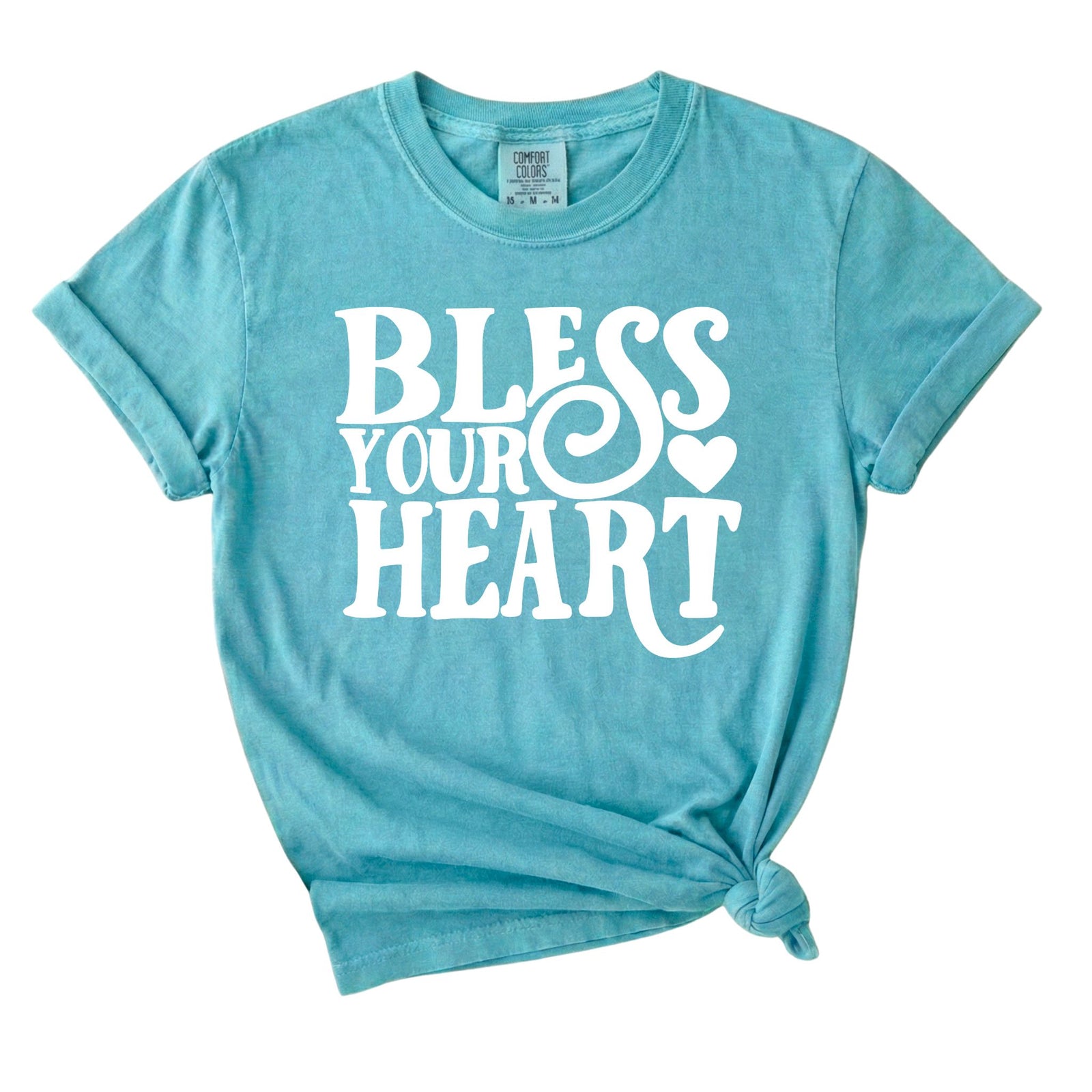 Chalky mint graphic t-shirt with white “Bless Your Heart” text and heart detail printed on the front.