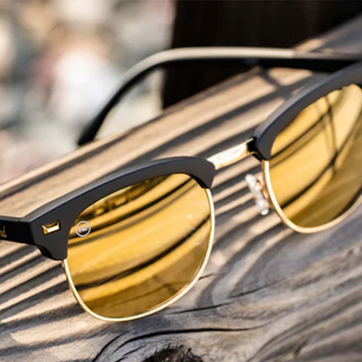 Close up photo of black and gold Knockaround sunglasses
