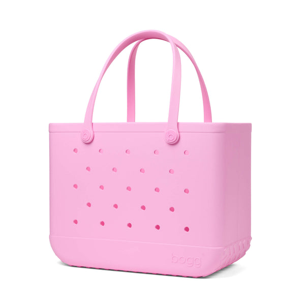 Pink Original Bogg Bag with handles raised shown in front of a white background.