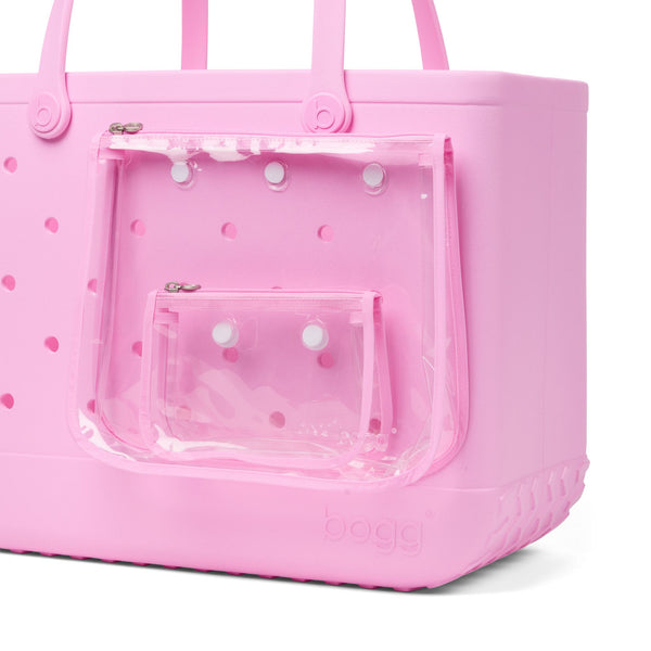 Pink Original Bogg Bag displaying a closeup of two zippered pouches attached to the side.