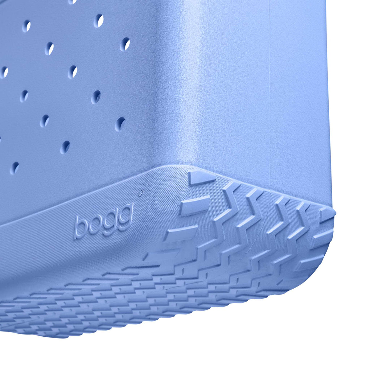 Close-up of a blue bogg bag with textured bottom and brand name.