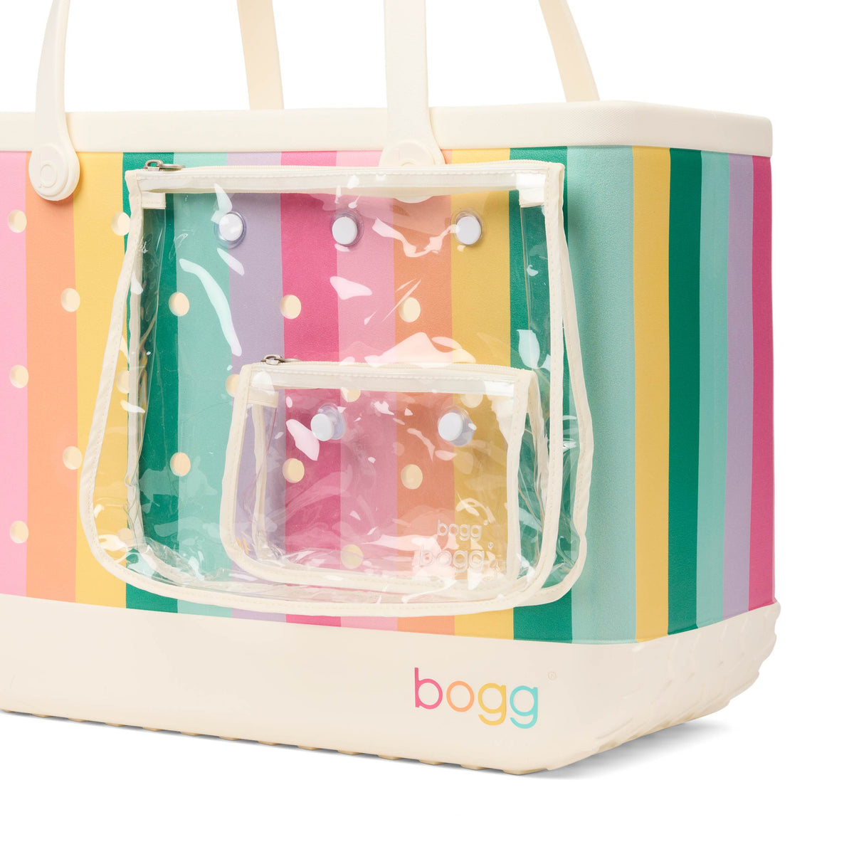 Bogg Bag in pastel rainbow stripe with cream base, featuring attached clear zippered pouch on front.