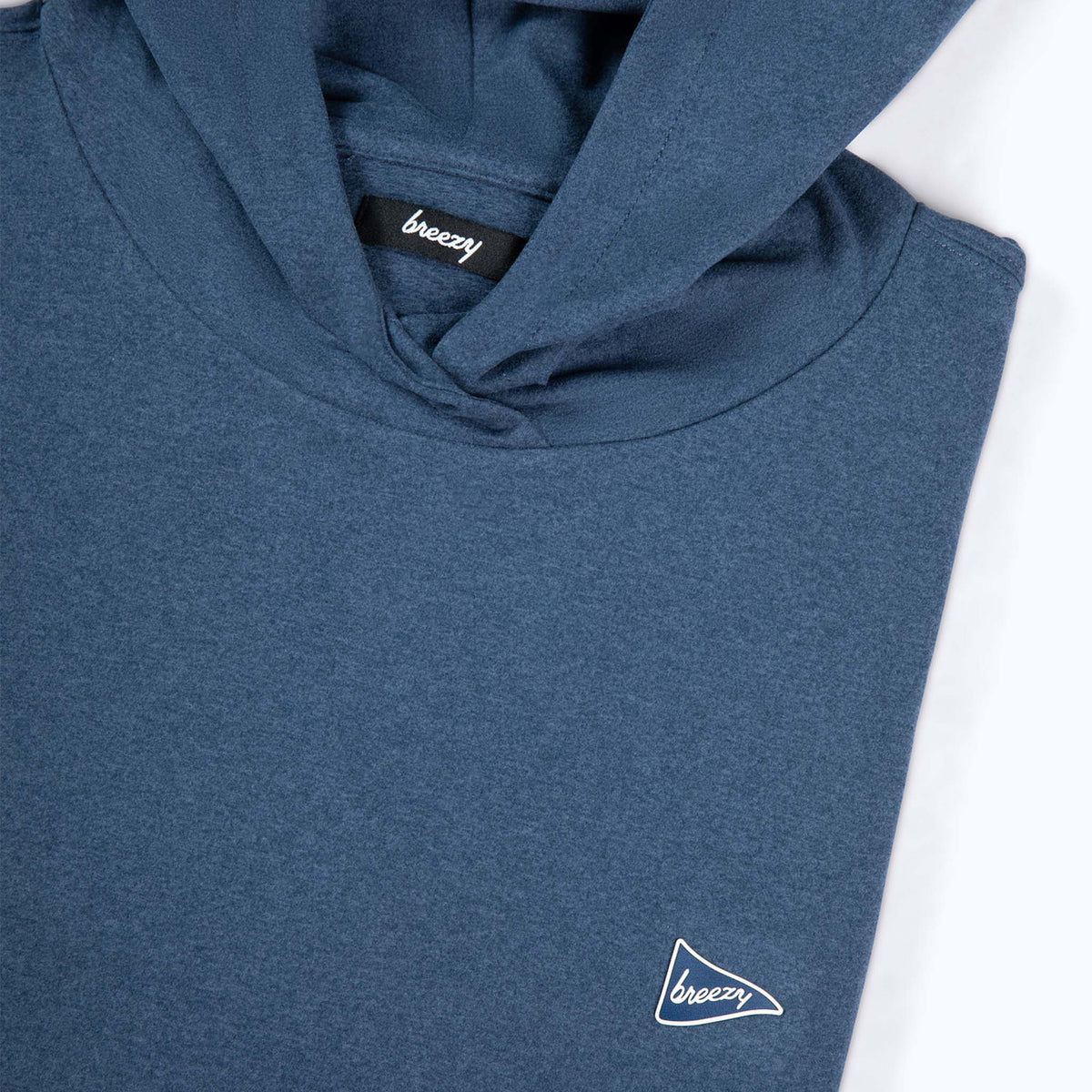 Close-up of Breezy hoodie chest showing hood, neckline, and small pennant logo detail.