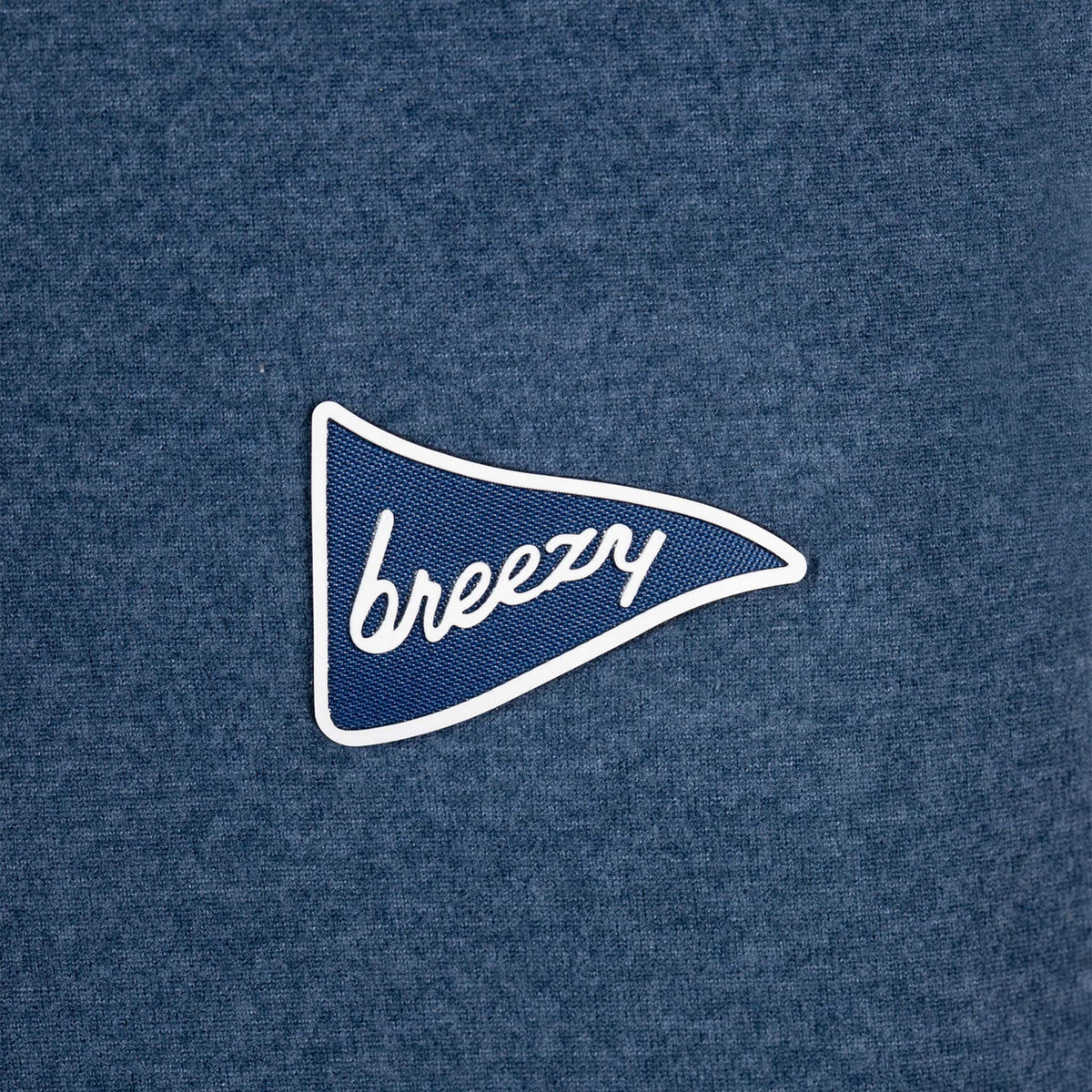 Detailed view of Breezy white pennant logo with script lettering on navy hoodie fabric.