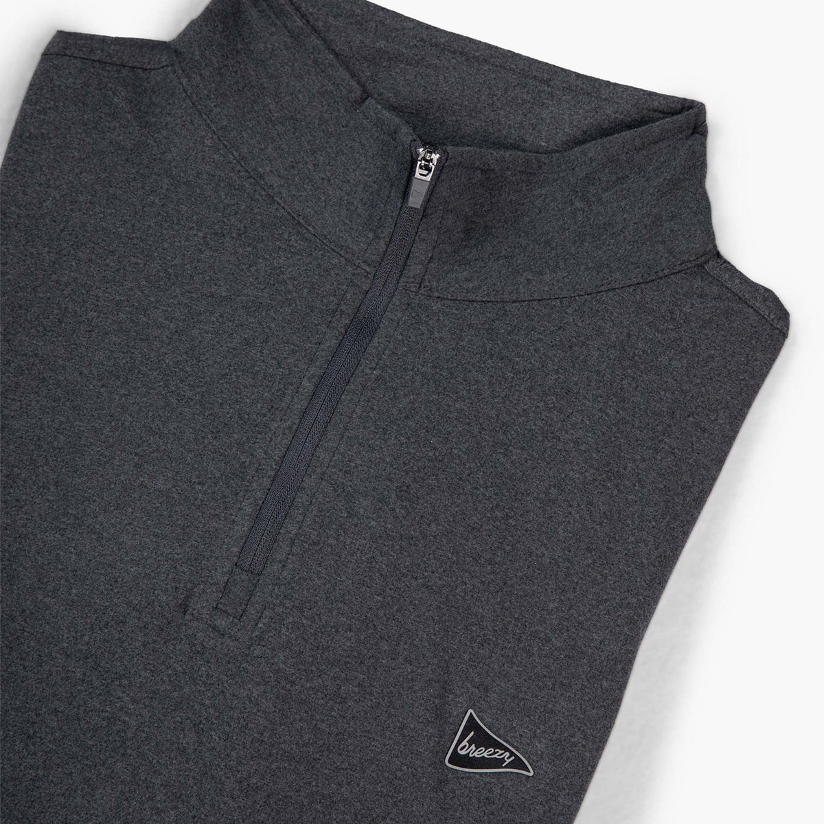 Flat lay angled view of Breezy charcoal quarter-zip pullover with chest logo.