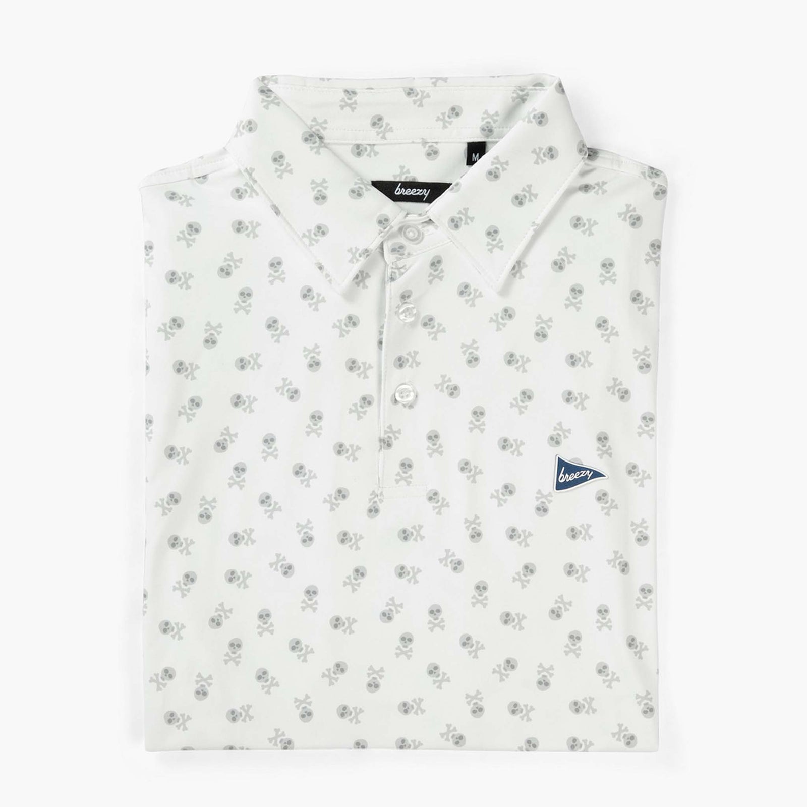 Folded Breezy white polo with gray skull and crossbones print, pointed collar, and navy pennant logo on left chest.