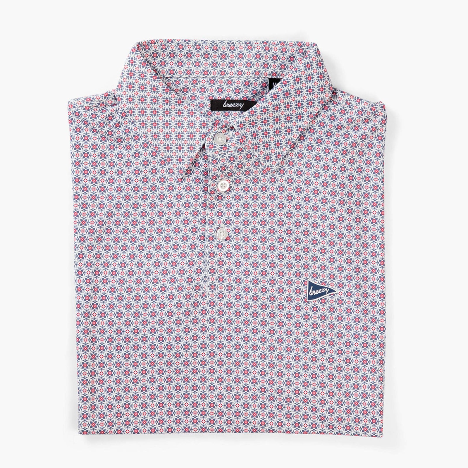 Breezy RWB patterned polo shirt folded flat with button placket and allover red, white, and blue geometric design.