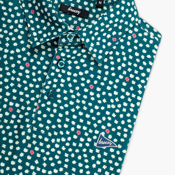 green shirt with small white floral pattern and 'breezy' branding on a white background