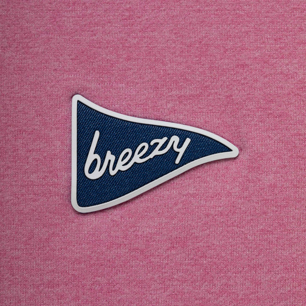 Blue and white 'breezy' patch on a pink textured background