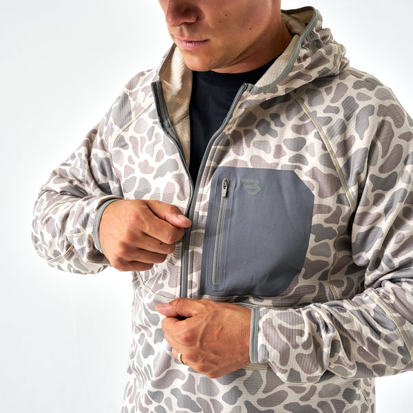 Men’s camo performance quarter-zip hoodie in light gray and taupe with chest pocket, shown partially zipped up.