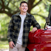Man standing next to a vintage red truck.