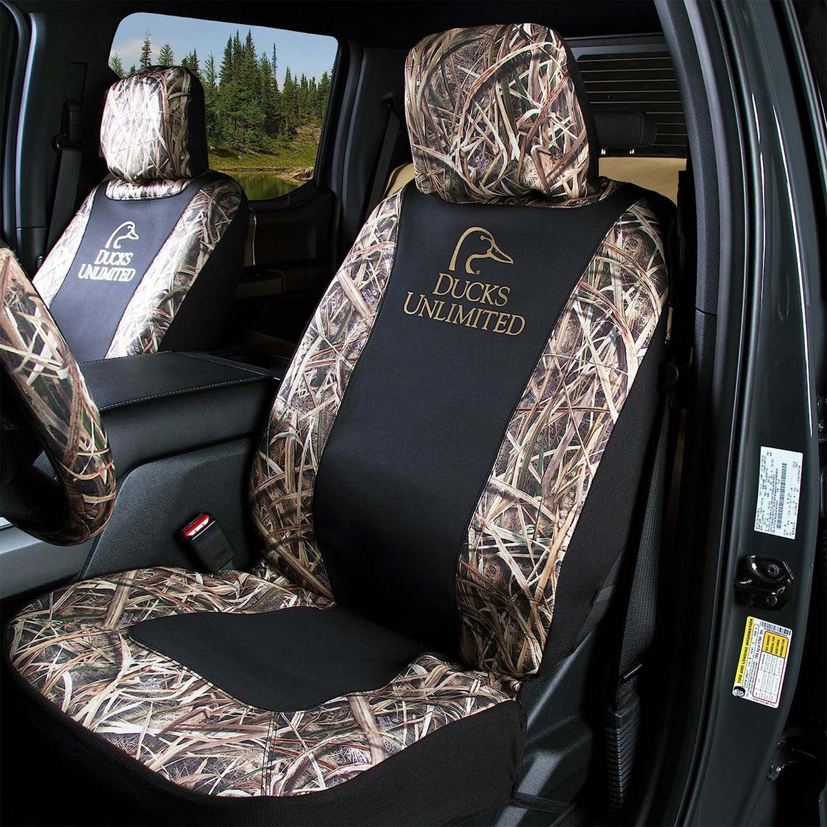 Ducks Unlimited seat covers installed in front seats of a truck, showing Realtree camo, black panels, and logo embroidery.