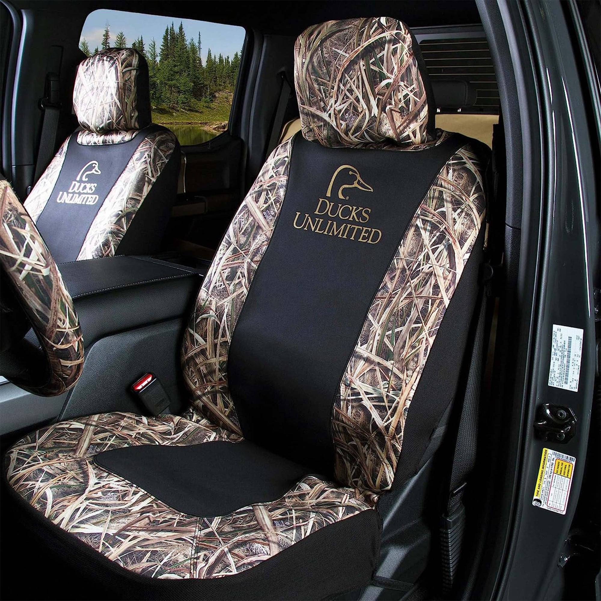 Ducks Unlimited seat covers installed in front seats of a truck, showing Realtree camo, black panels, and logo embroidery.