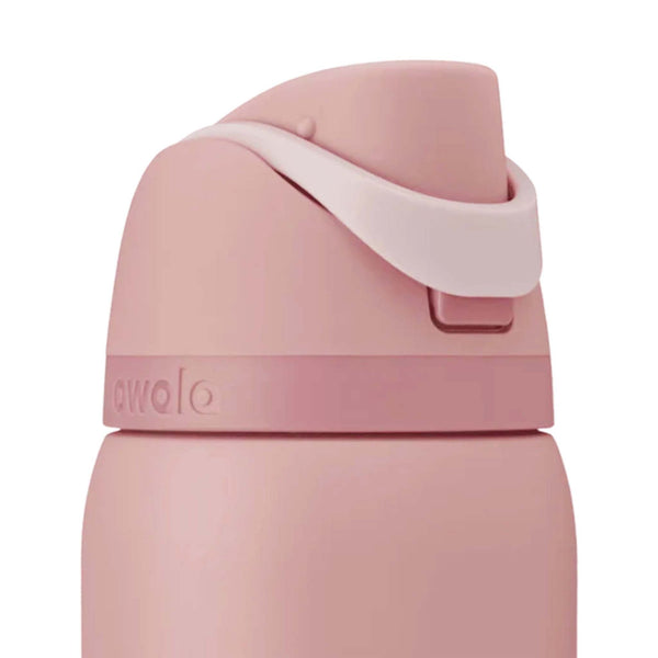 Close-up of the Owala FreeSip lid in Rose Quartz showing the carry loop snapped down. 