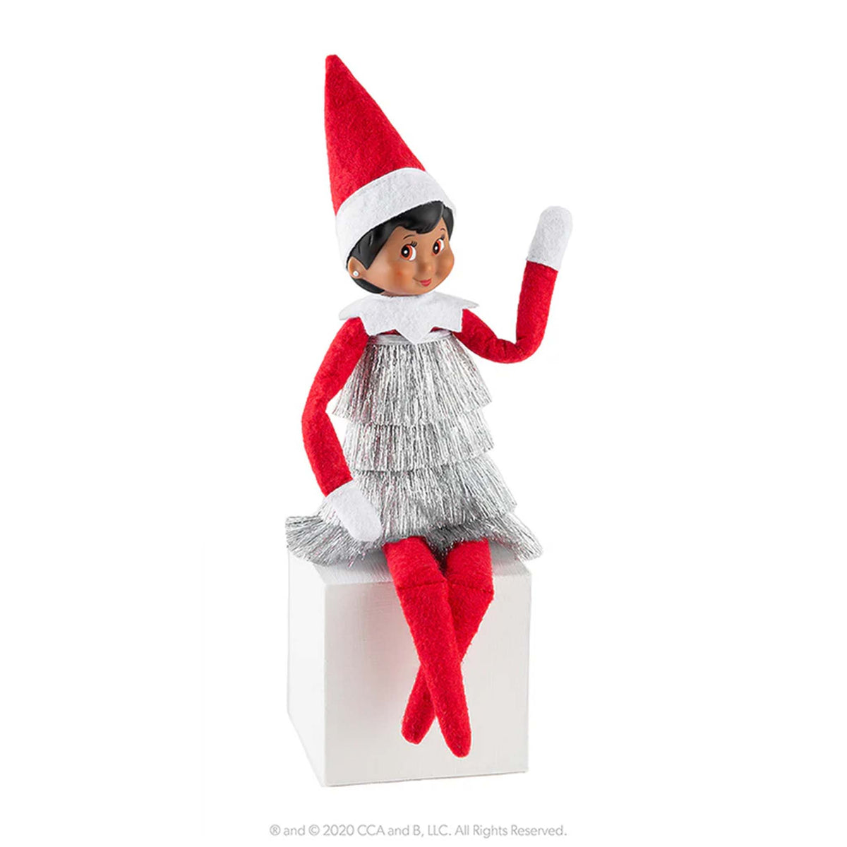 Elf on the Shelf doll in a silver dress and red hat on a white background