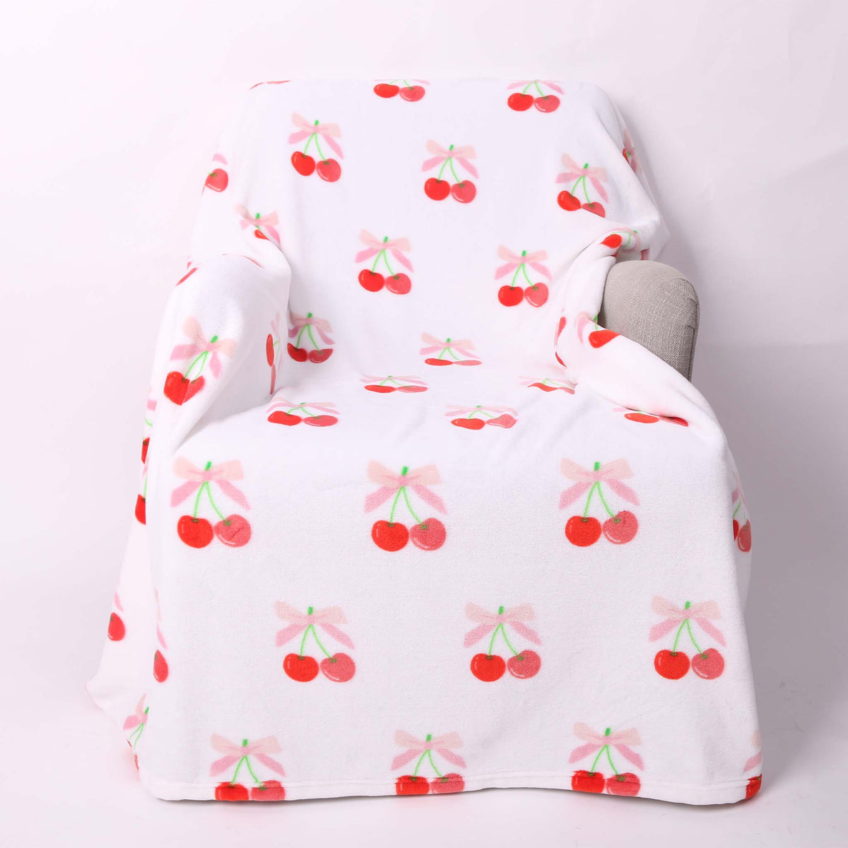 Light pink cherry printed fleece blanket.