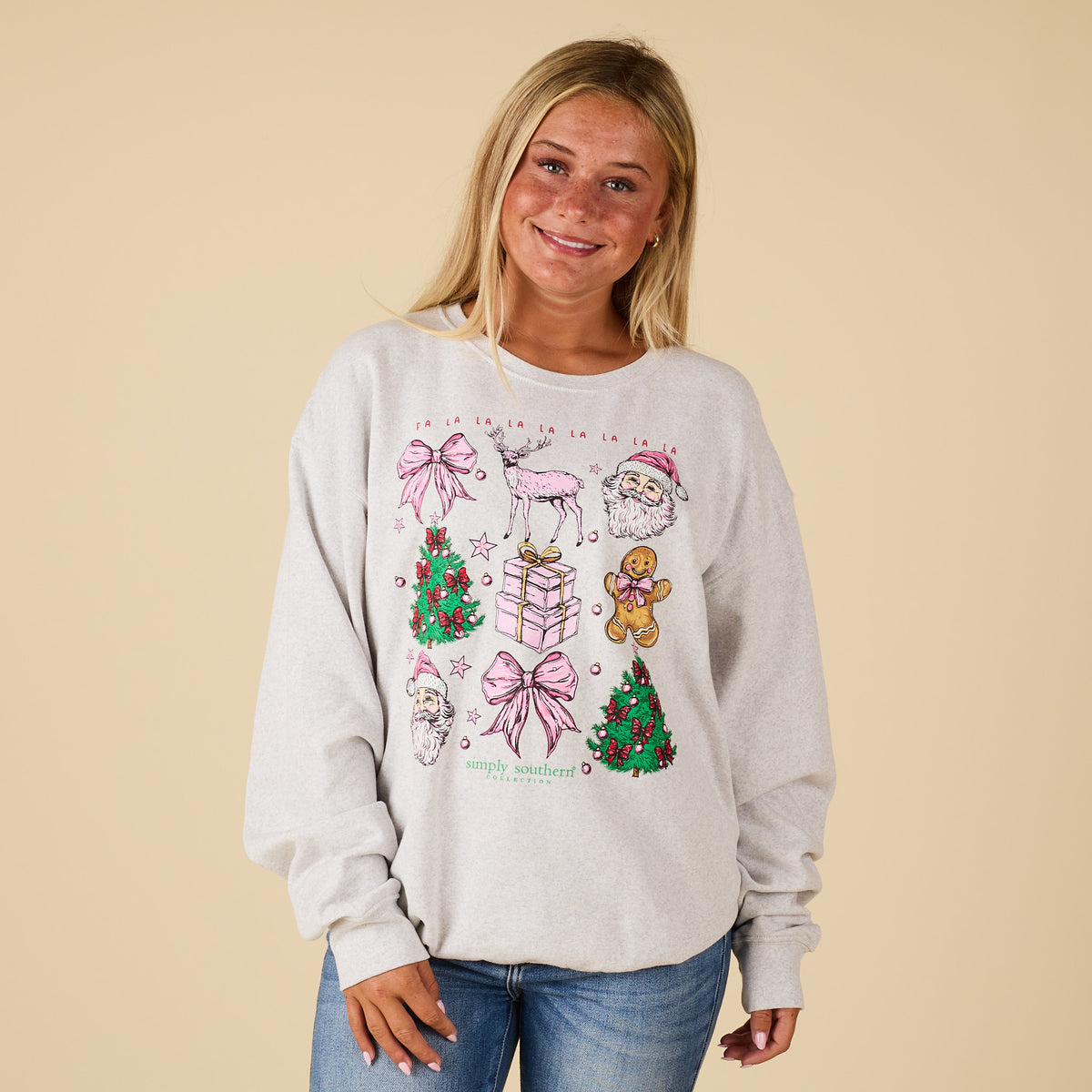 Front view of model wearing Simply Southern Christmas Grid Sweatshirt in heather grey with festive holiday icons.