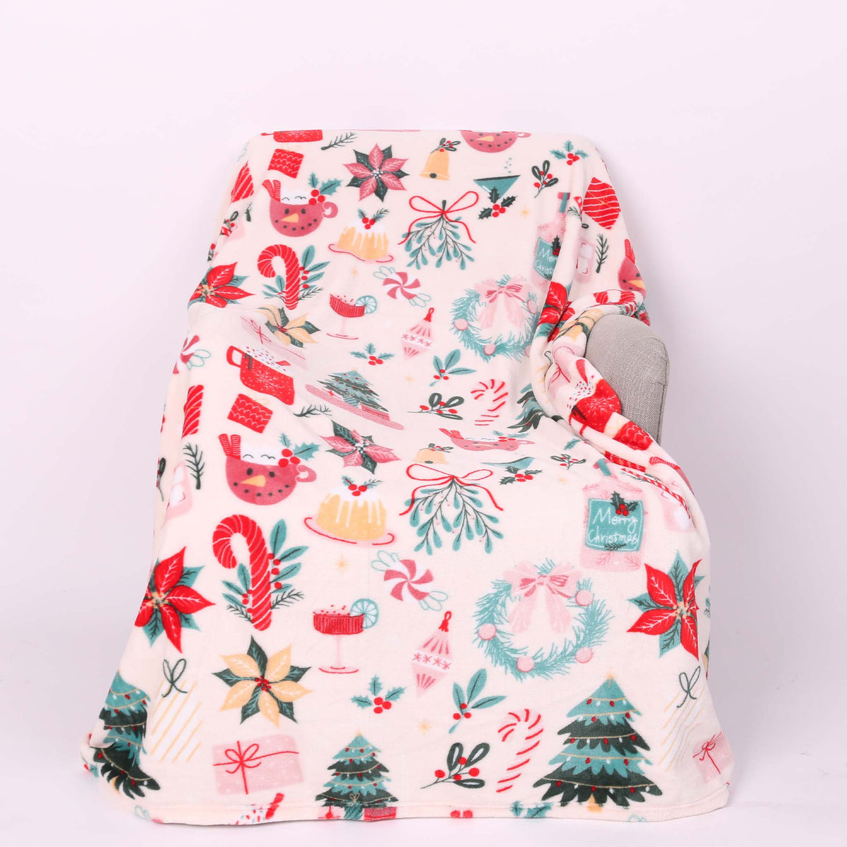 Christmas icon themed blanket with a pink base.