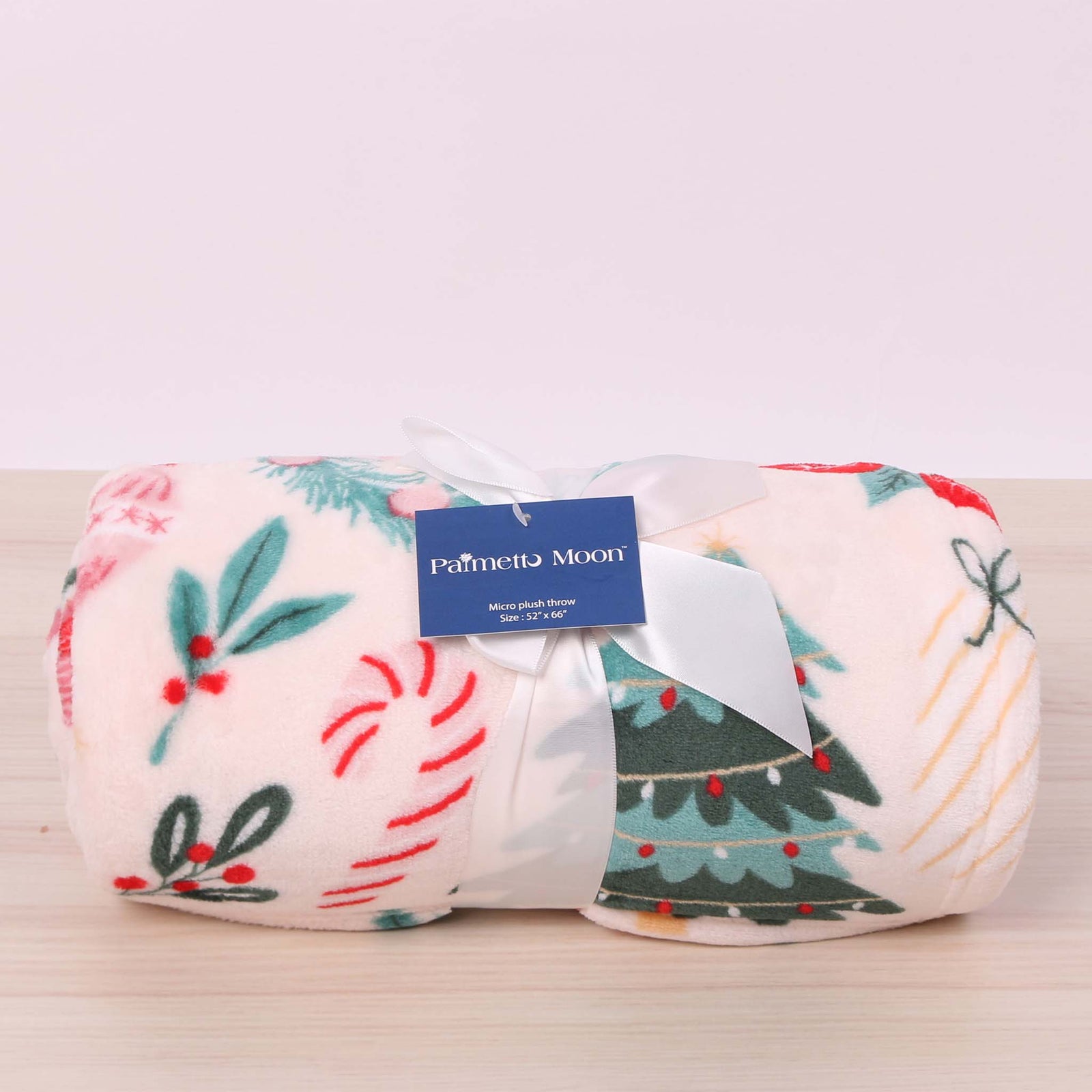 Christmas icon themed blanket with a pink base.