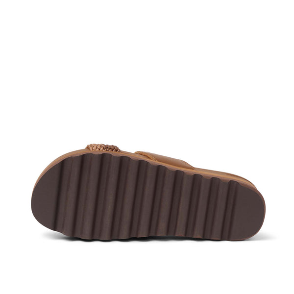 Black athletic shoe sole with red accents on a white background