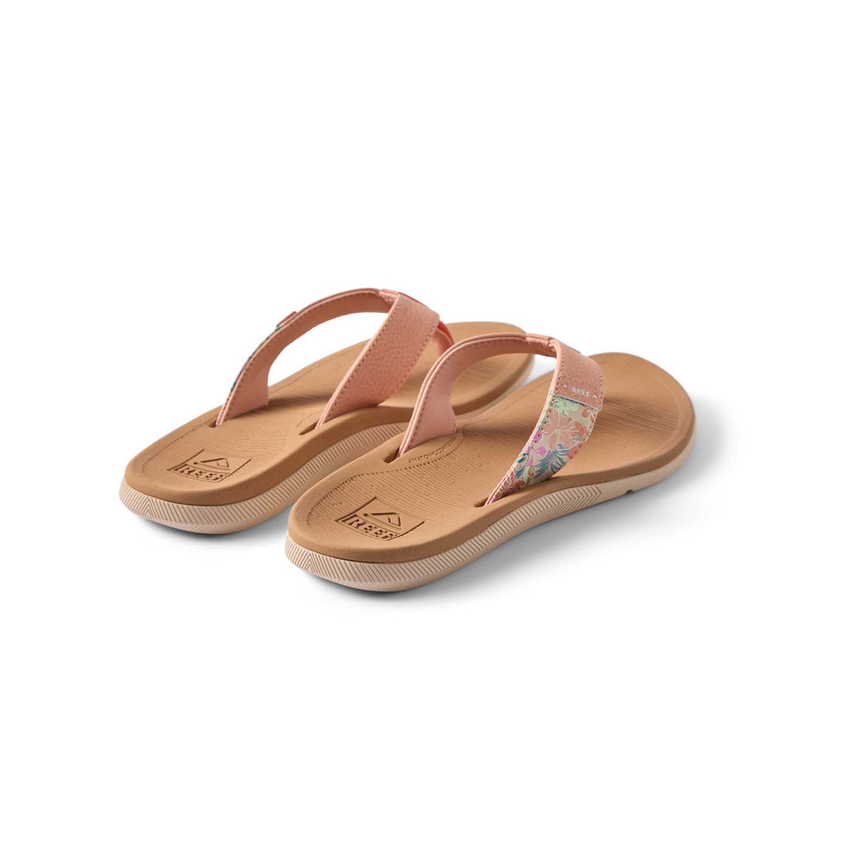Pair of pink sandals with floral strap on a white background