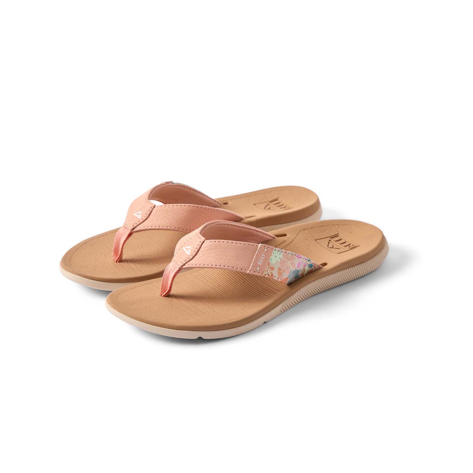 Pair of pink sandals with floral design on a white background