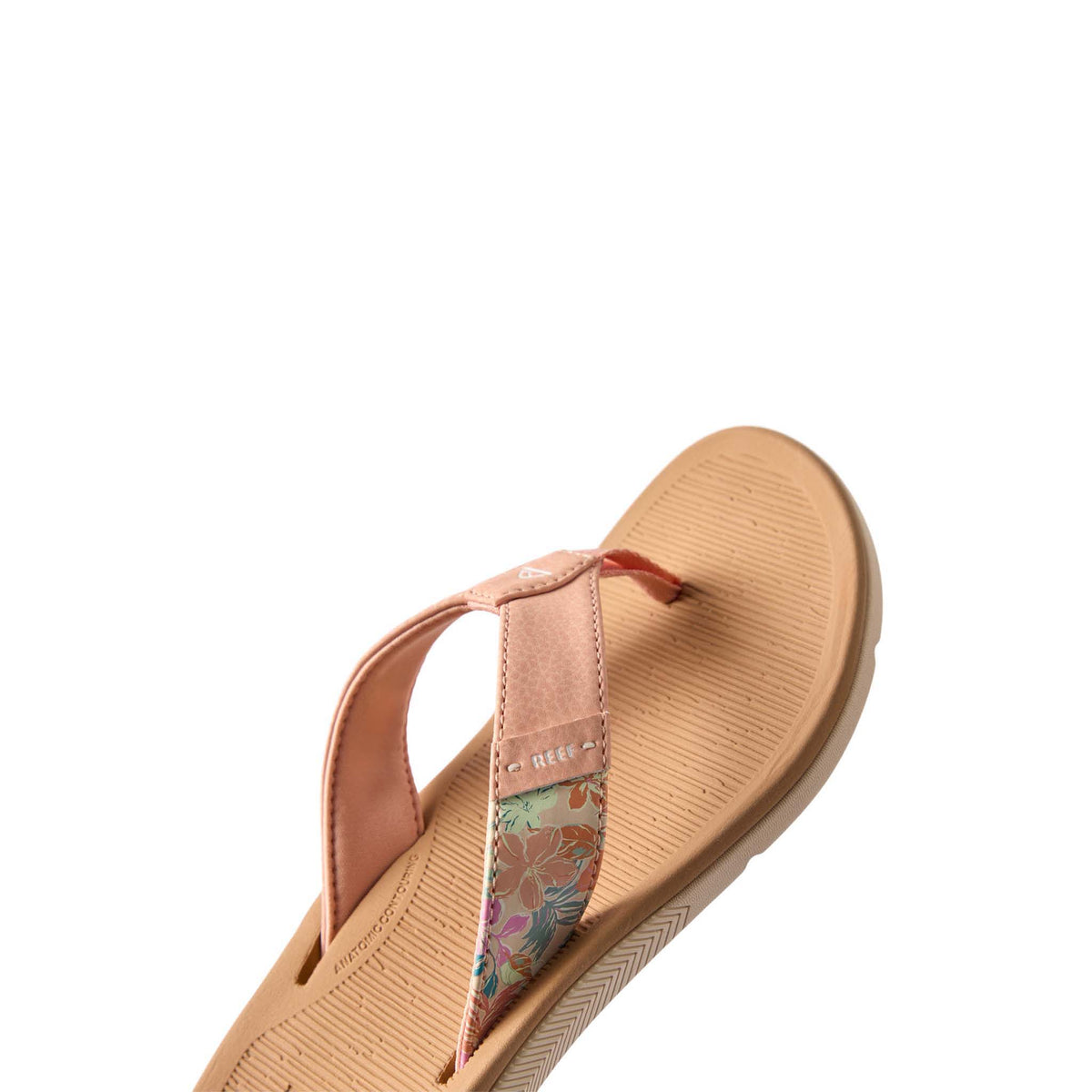 Beige sandal with floral strap on a white background