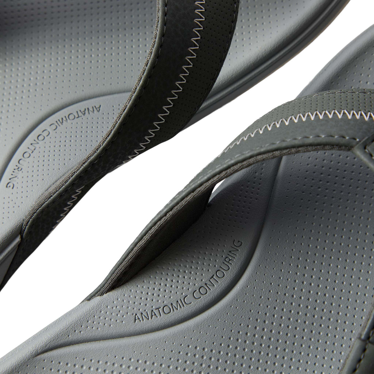 Close-up of gray sandals with 'Anatomic Contouring' text on a white background