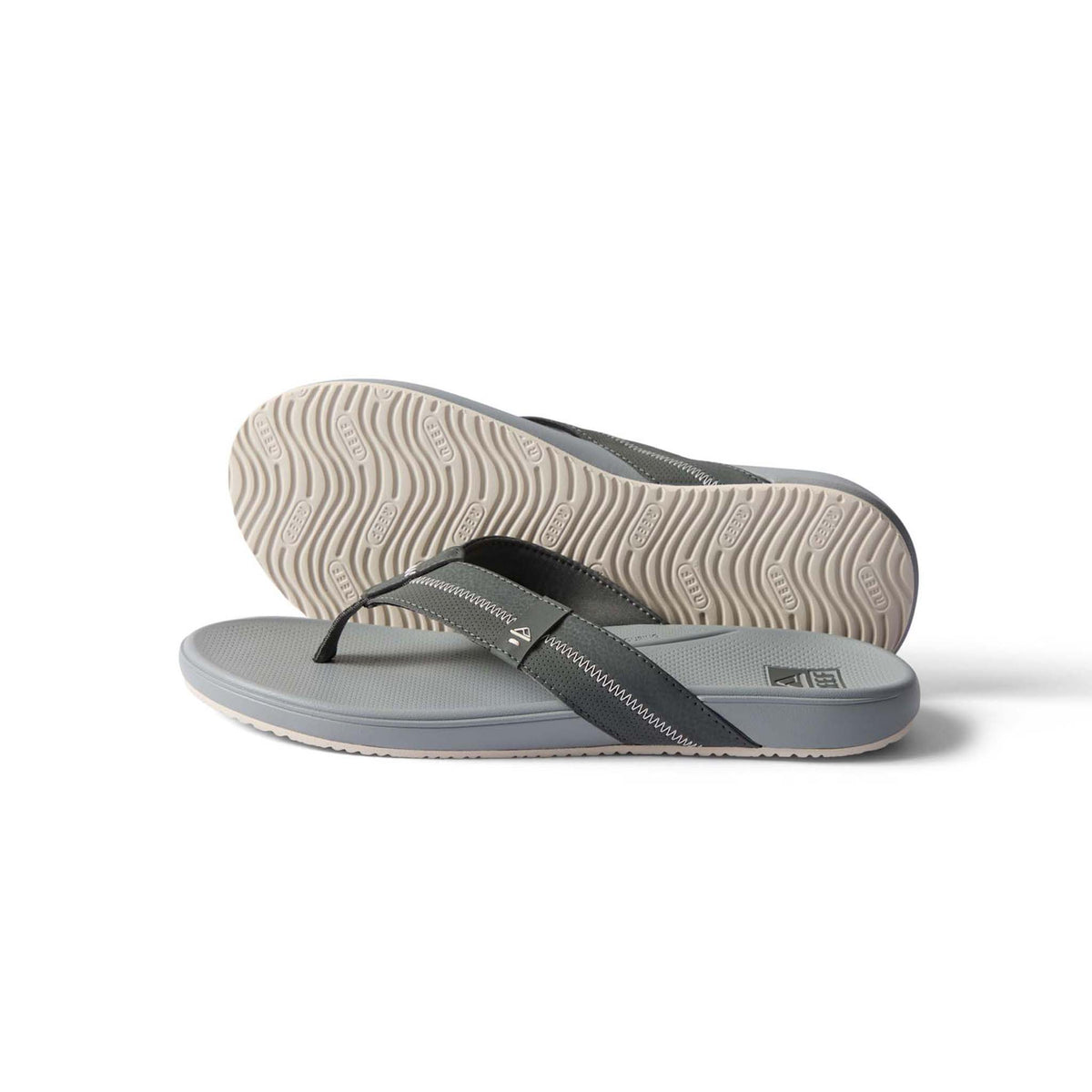 Gray flip-flops with a black strap on a white background