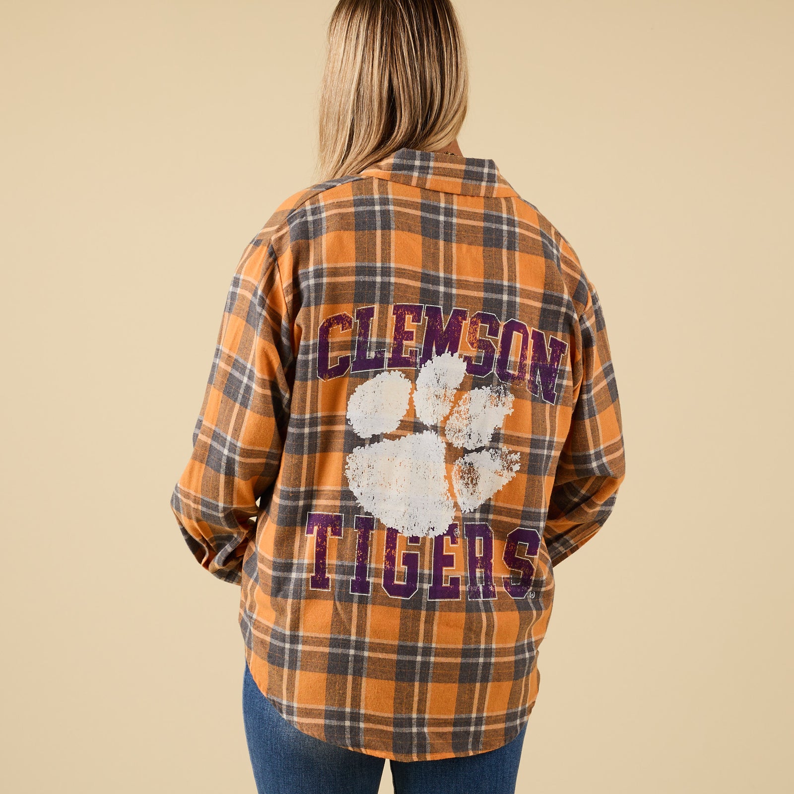 Plaid shirt with 'Clemson Tigers' text and paw print on a beige background