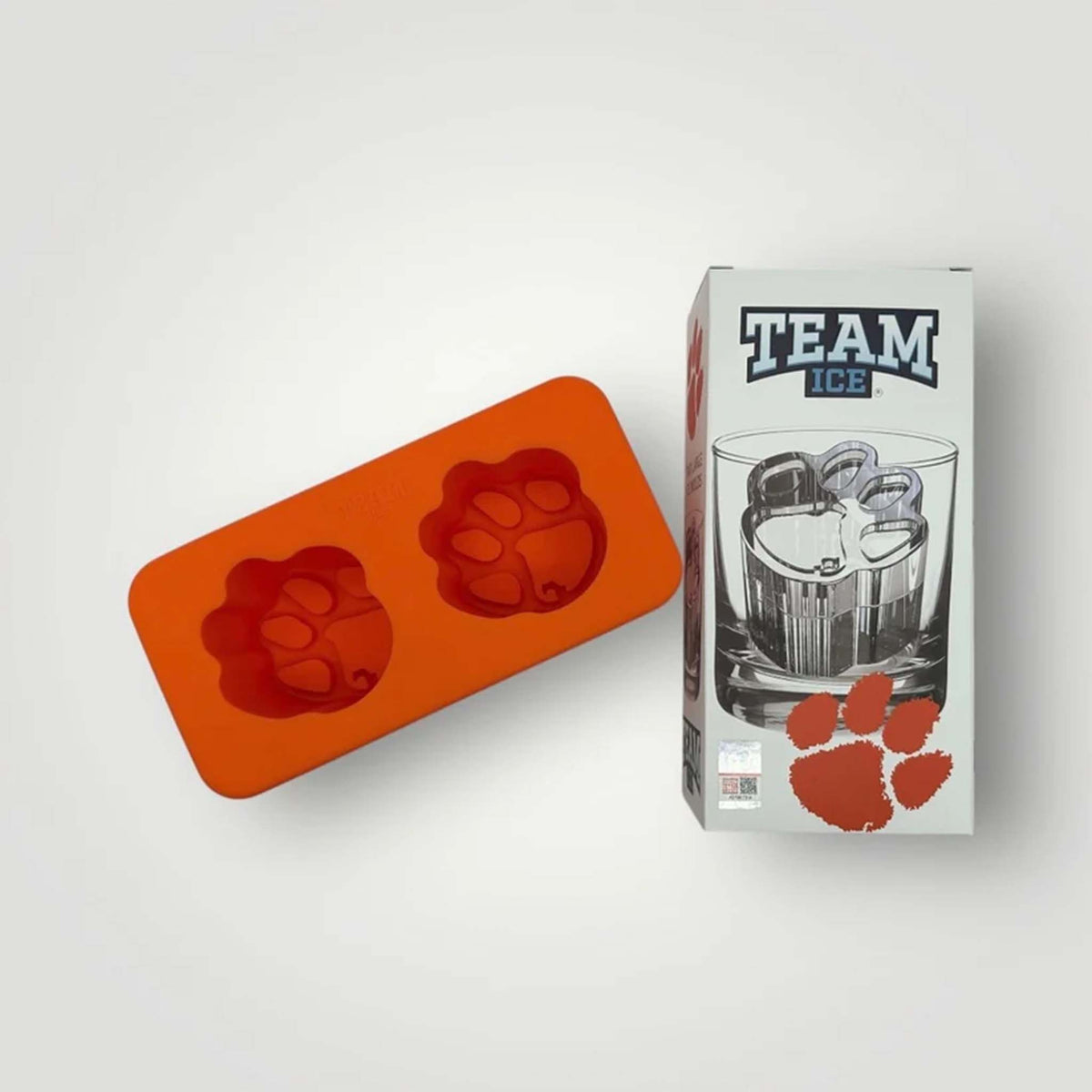 Orange silicone Clemson University ice mold with two paw cavities shown next to branded box.