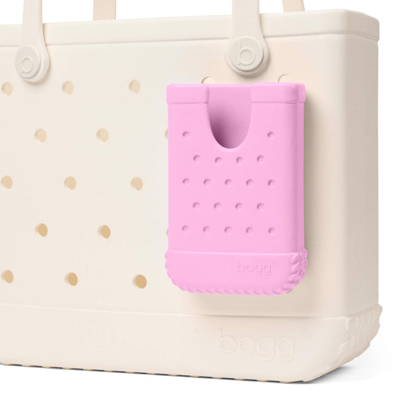 Pink textured phone case attached to a Beige Bogg Bag shown on a white background.