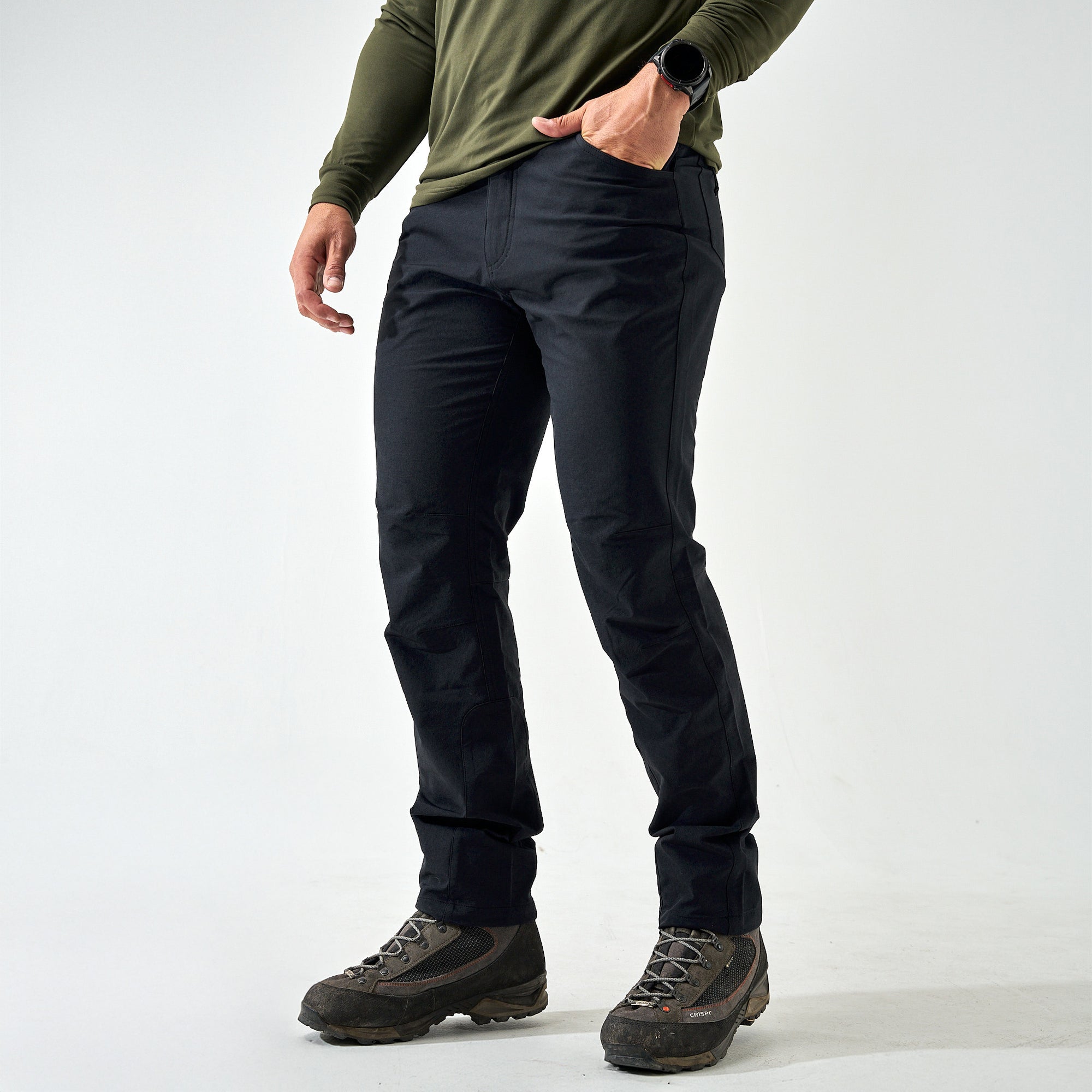 Burlebo Challenger Pants in black shown full length with hiking boots, styled with an olive long sleeve shirt.