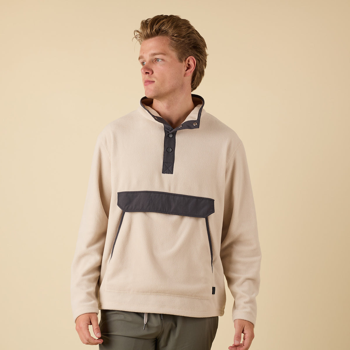 Front-facing image of oatmeal Crosby Fleece Quarter Snap Pullover with charcoal snap collar and front pocket.