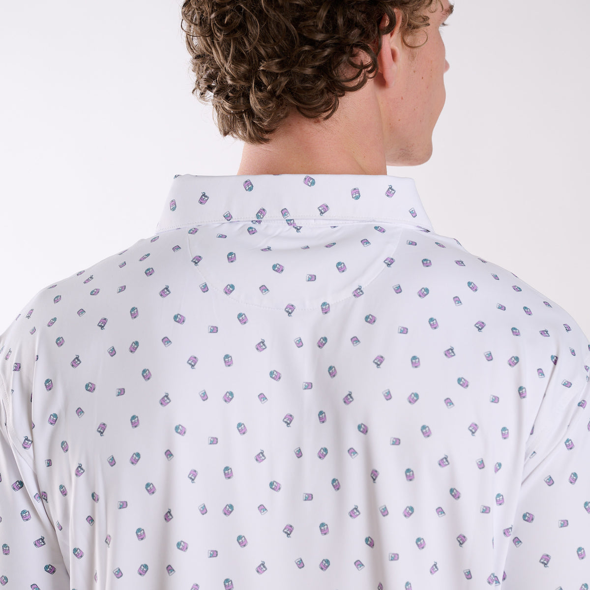 Rear collar detail of COAST Transfusion Icon Printed Polo in white showing the small transfusion cocktail icon print across the upper back.