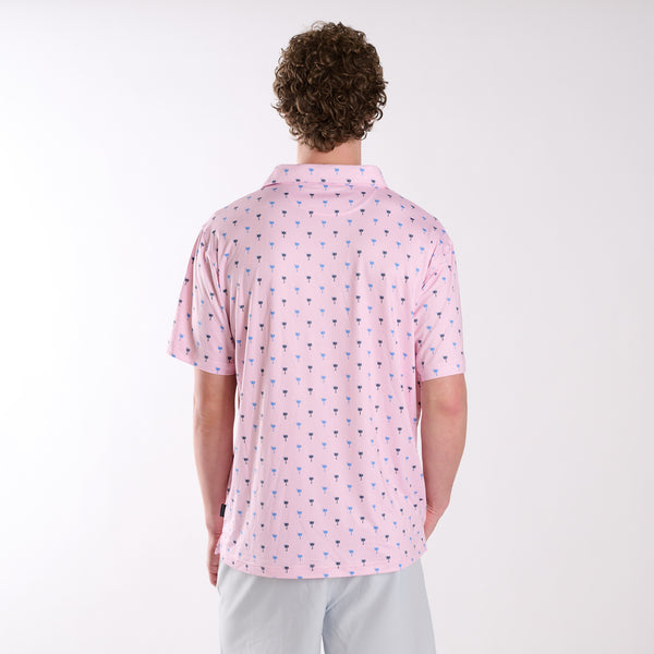 Rear view of COAST South Carolina Palm Tree Printed Polo in pink with small blue and navy palm tree icons across the fabric.