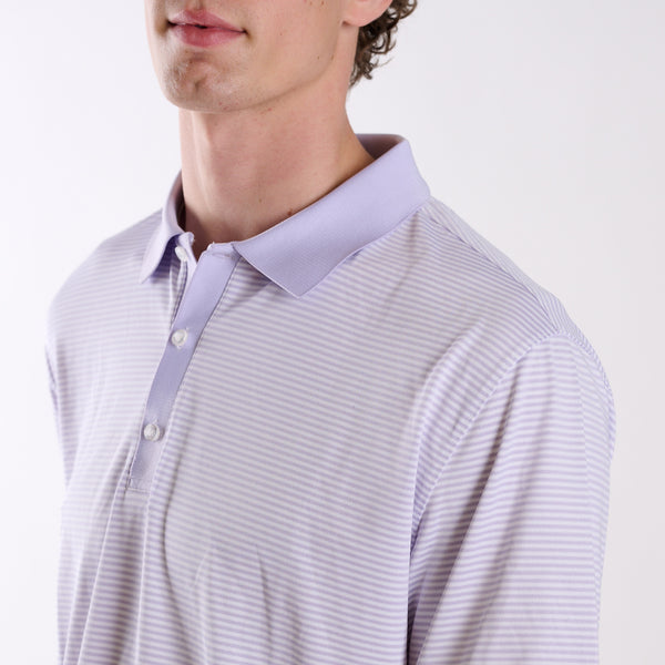 Close-up of COAST micro-stripe performance polo in light lavender with white stripes, featuring a classic collar and three-button placket.