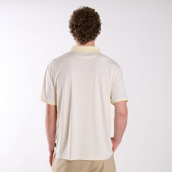 Back view of COAST micro-stripe performance polo in pale yellow with white stripes, shown on a model in a studio setting.