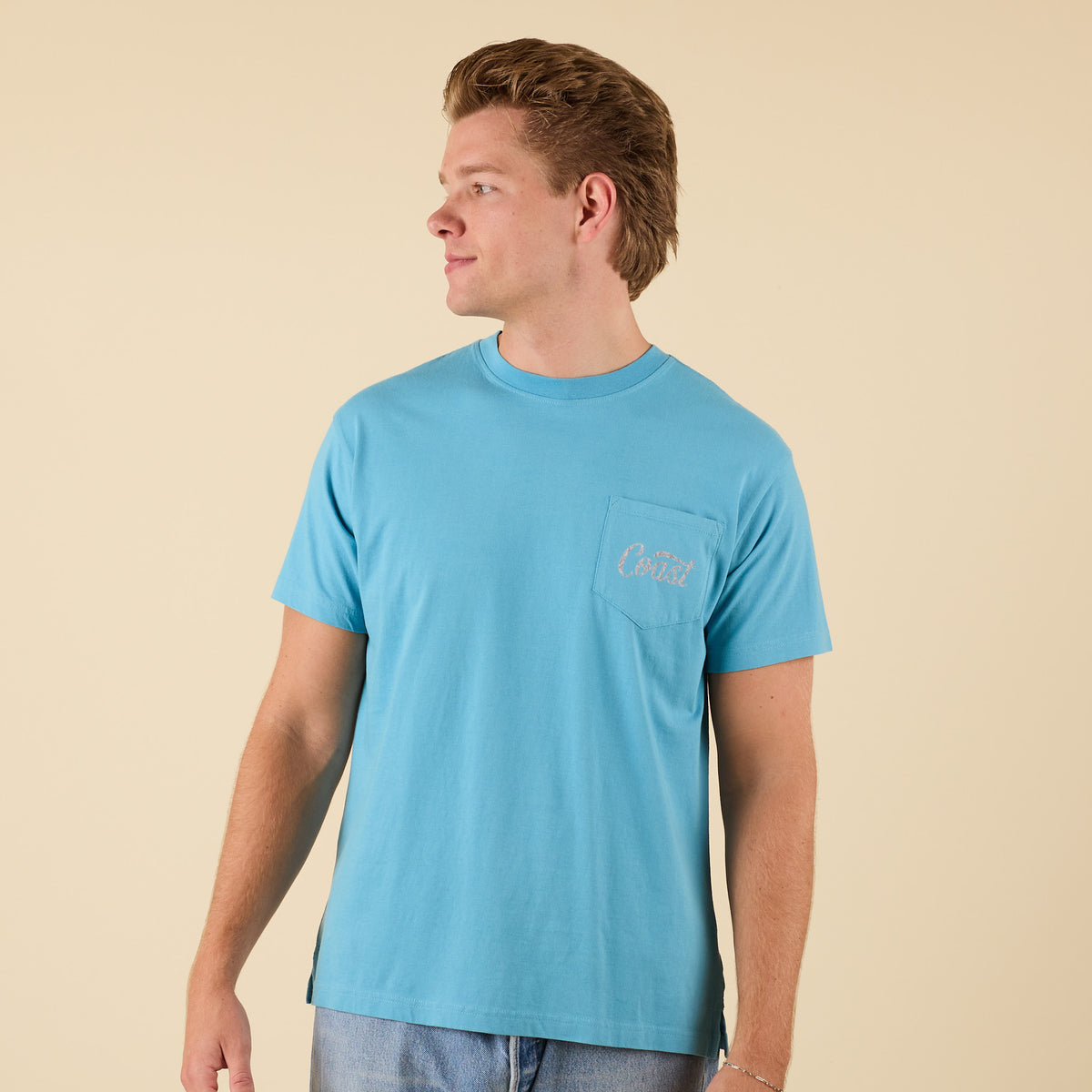 Front view of COAST Camo Label aqua blue pocket t-shirt with small COAST logo on chest.