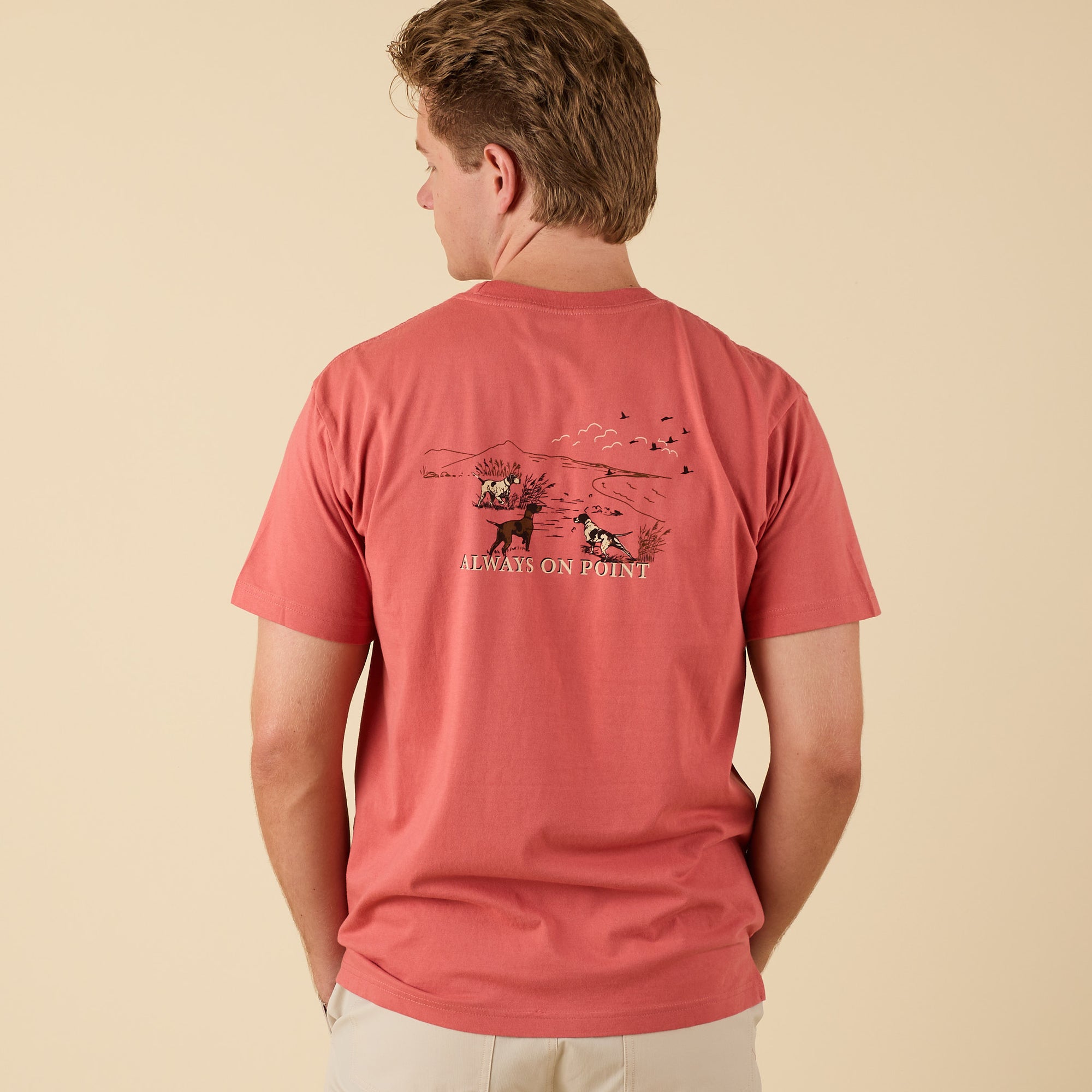 Back view of COAST Always On Point tee showing hunting dog field graphic and “Always On Point” text.